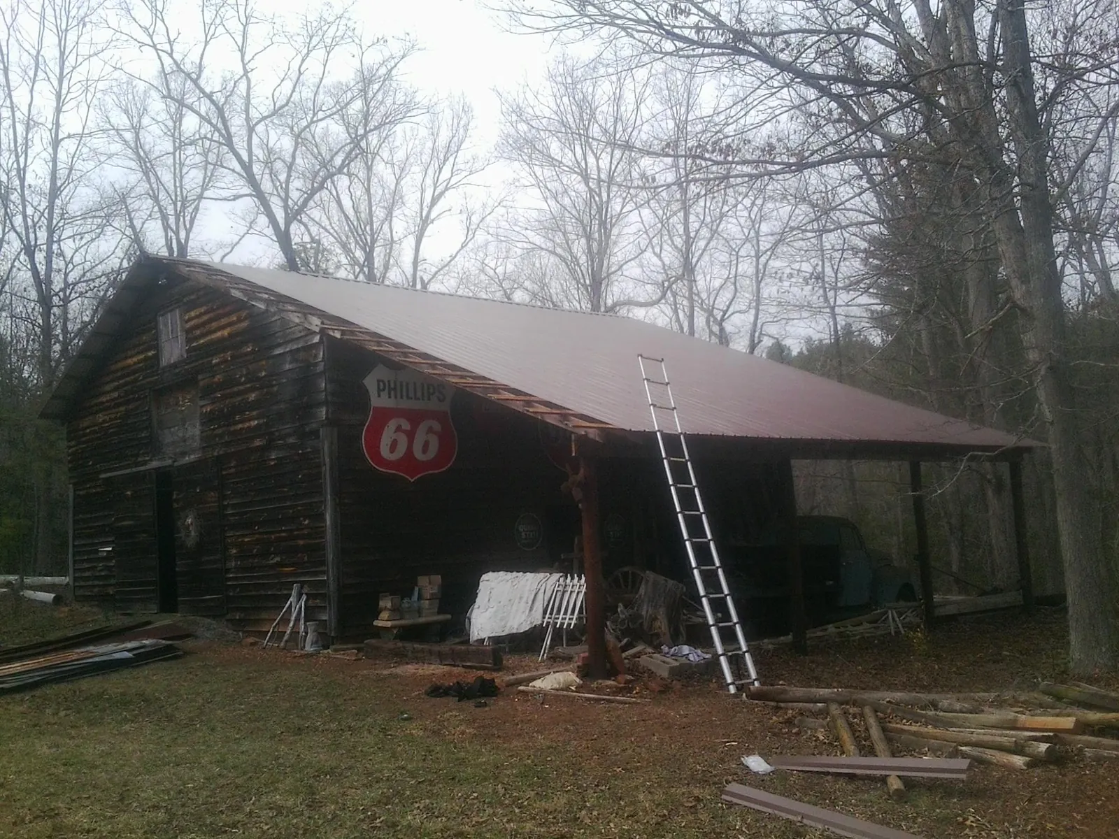 New metal roof on an open sided timber barn with a vintage sign in Nashport