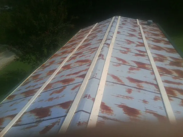 Rusted metal roof panels with new wood purlins before replacement — Storm Damage Roof Repair in Nashport by Roofing Brothers