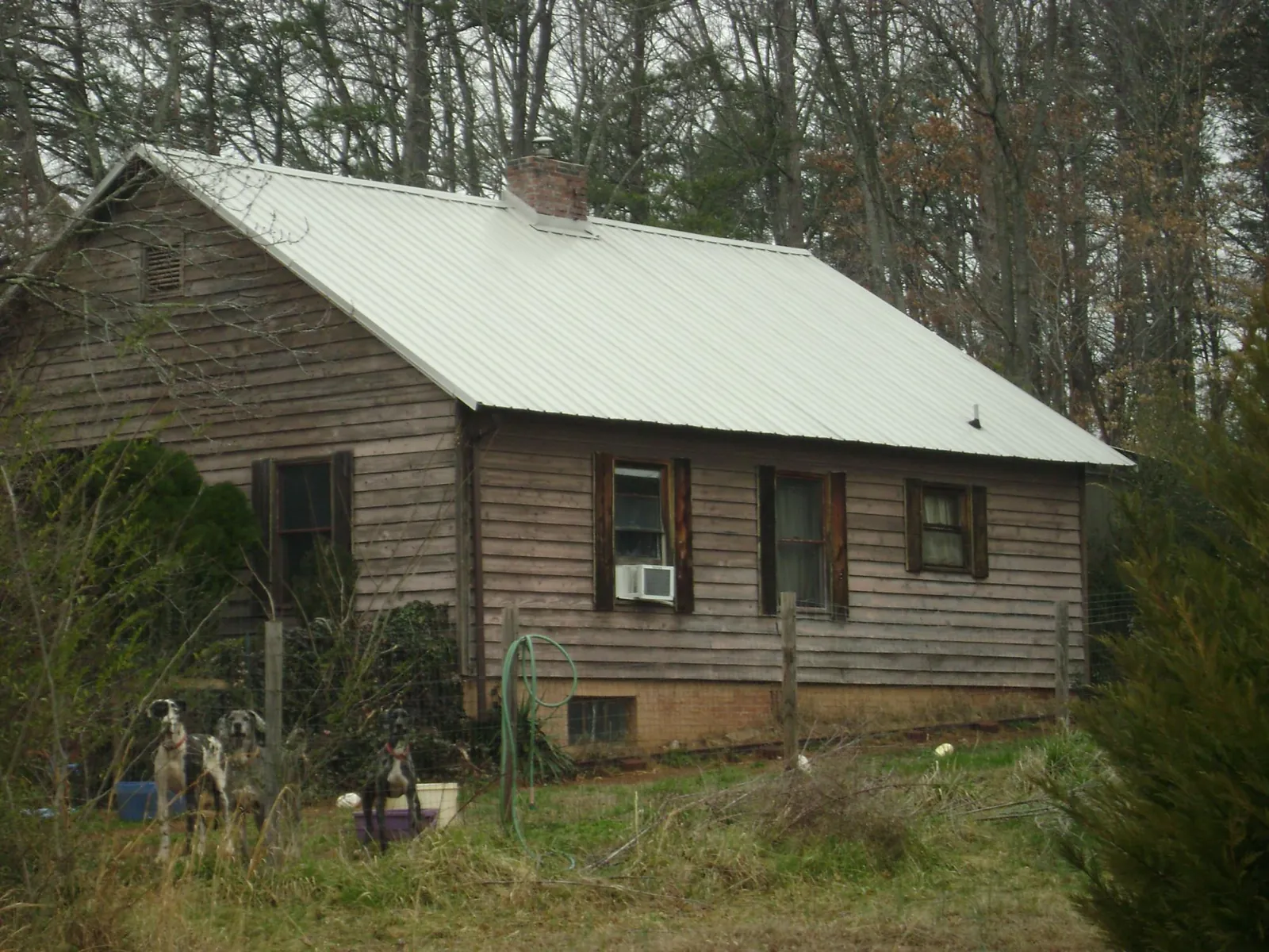 White metal roof on an old wood sided farmhouse, from a Metal Roof Installation job in Nashport
